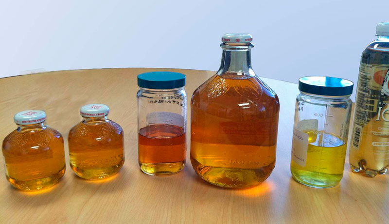 Photo illustrating the visible similarities between liquid pesticides and common drinks such as apple juice.