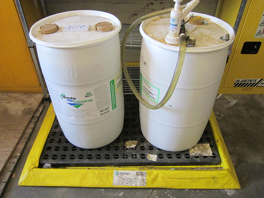 Photo of proper pesticide storage or two 30 gallon containers of herbicide.